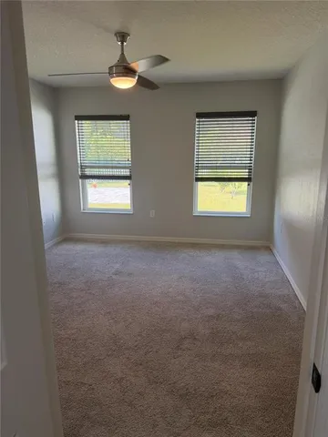a bathroom with a glass shower door and a window