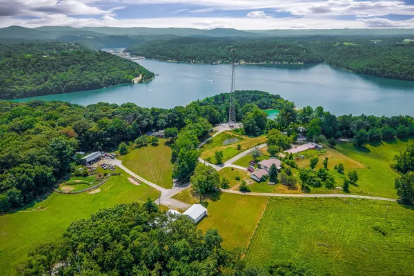 an aerial view of a house with a yard and lake view