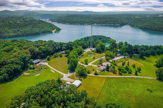 an aerial view of a house with a yard and lake view