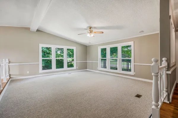 an empty room with a empty space and windows