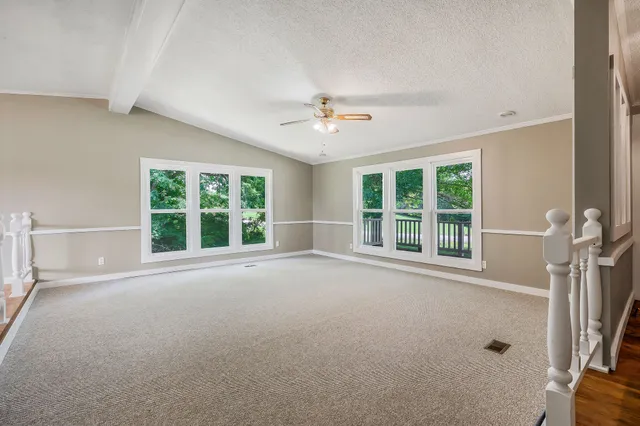 an empty room with a empty space and windows