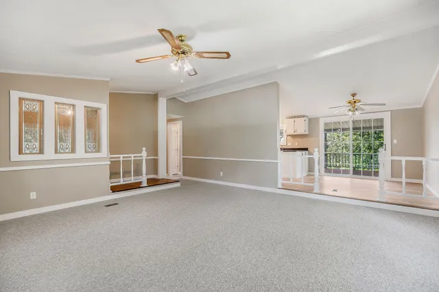 a view of a kitchen with wooden floor and a floor to ceiling window