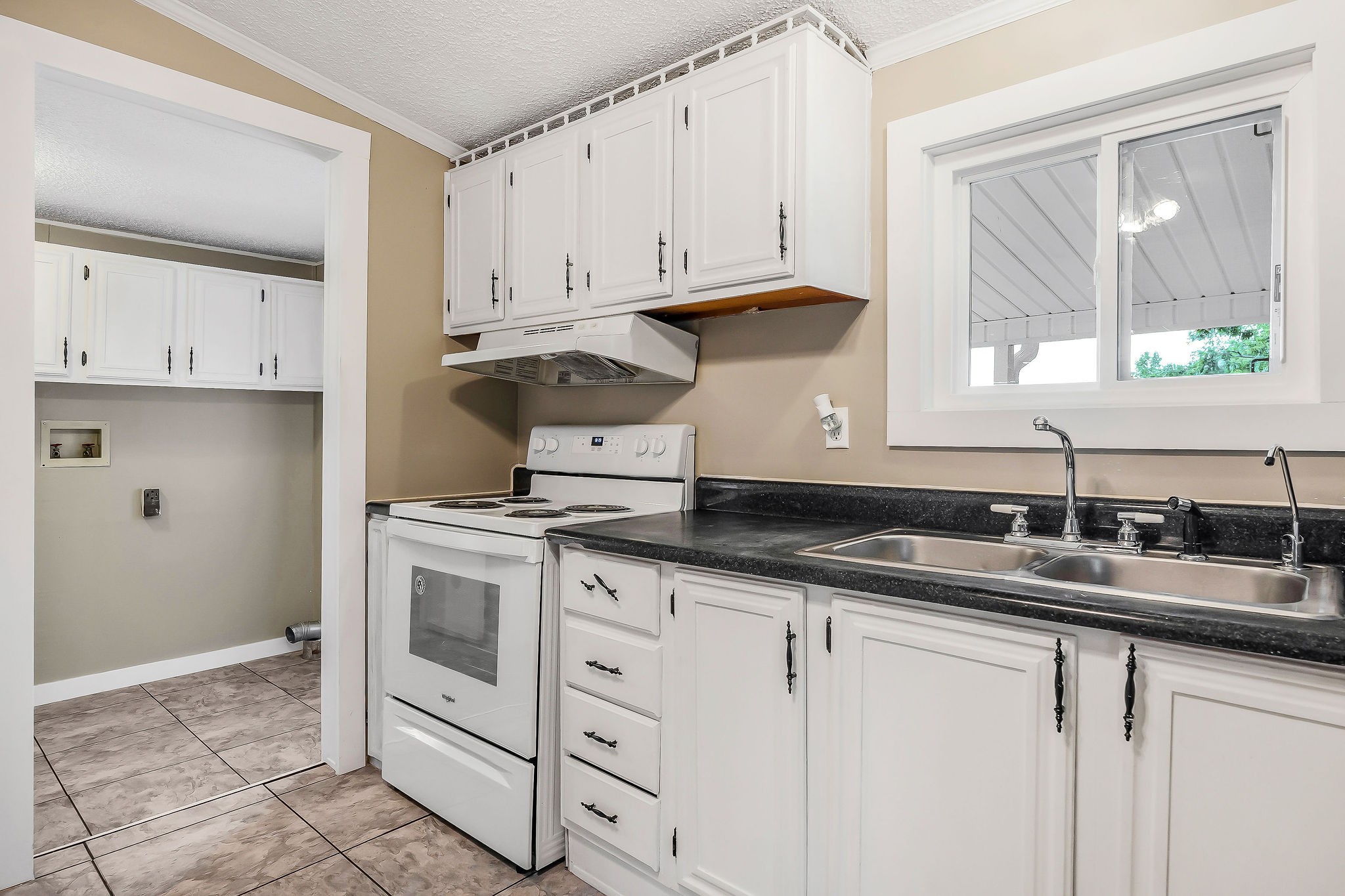 572 Lakeside Road Byrdstown, TN 38549 - Photo 20 of 44 a kitchen with granite countertop a sink stove and cabinets