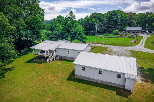an aerial view of a house with backyard space and swimming pool