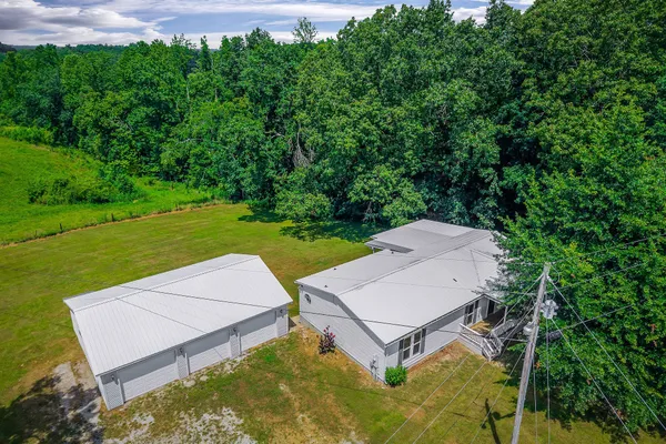 an aerial view of a house with garden space and street view