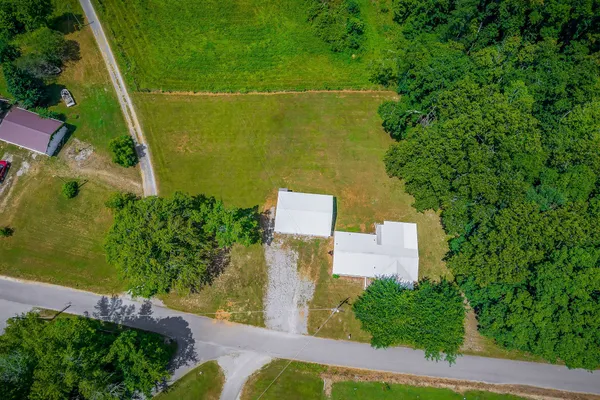 an aerial view of a house with a yard
