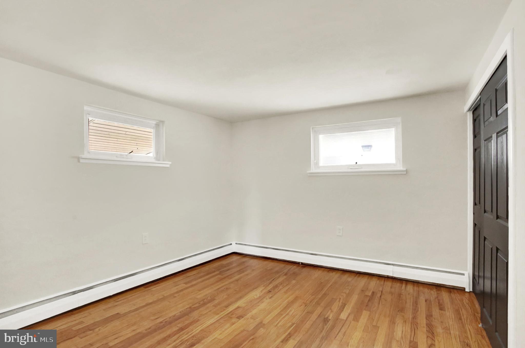 507 Magaro Road Enola, PA 17025 - Photo 18 of 35 an empty room with wooden floor and windows