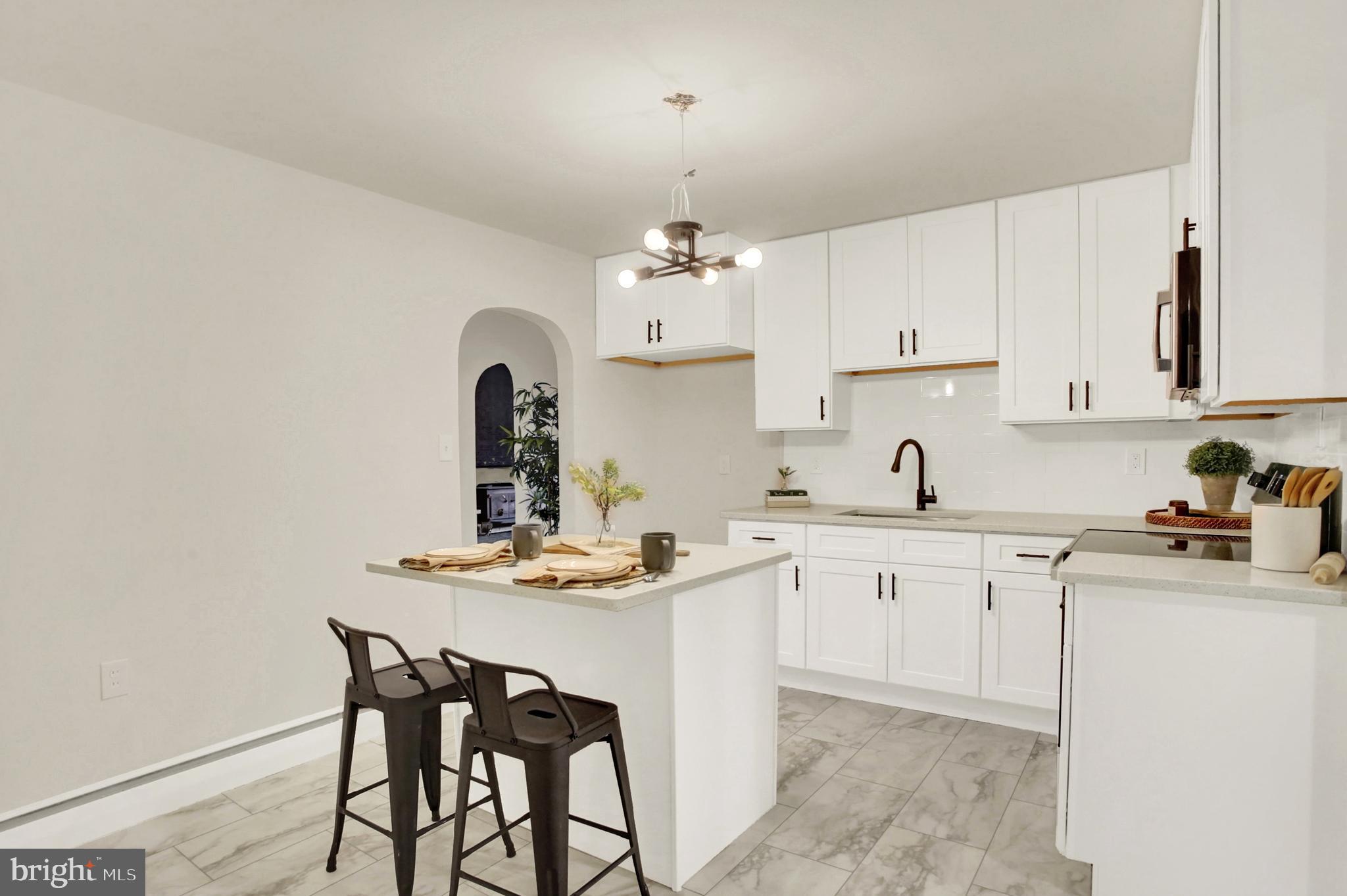 507 Magaro Road Enola, PA 17025 - Photo 10 of 35 a kitchen with stainless steel appliances granite countertop a sink dishwasher and white cabinets with wooden floor