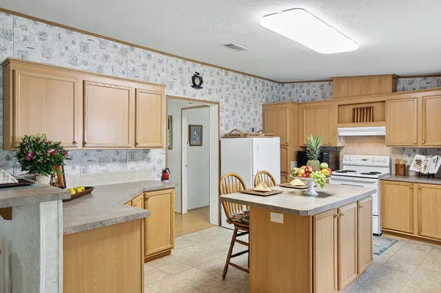 a kitchen with a sink a stove cabinets and refrigerator