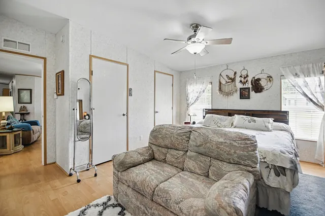 a bedroom with a large bed and a chandelier