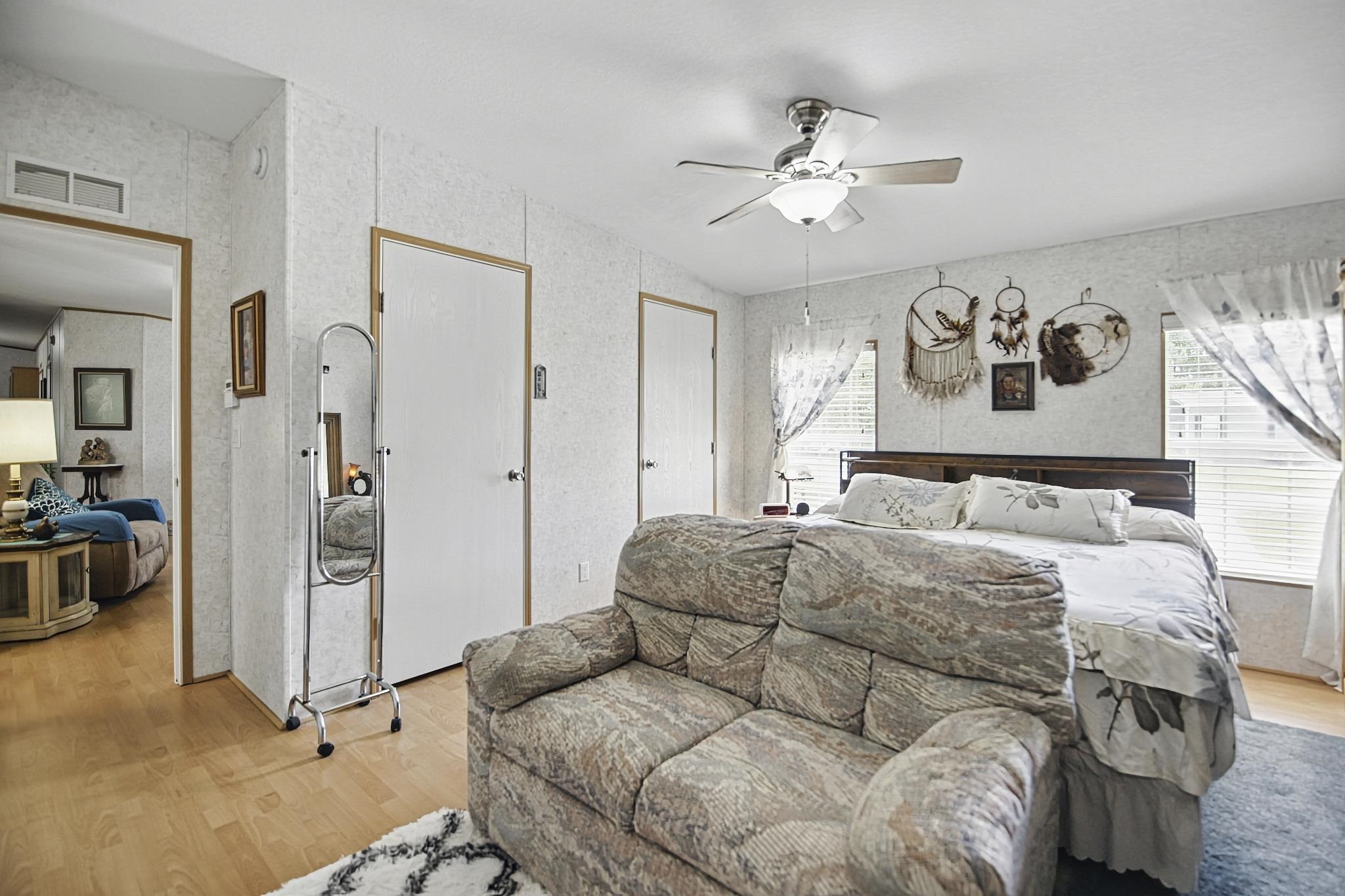 2257 Whippoorwill Drive St. Augustine, FL 32084 - Photo 16 of 50 a bedroom with a large bed and a chandelier