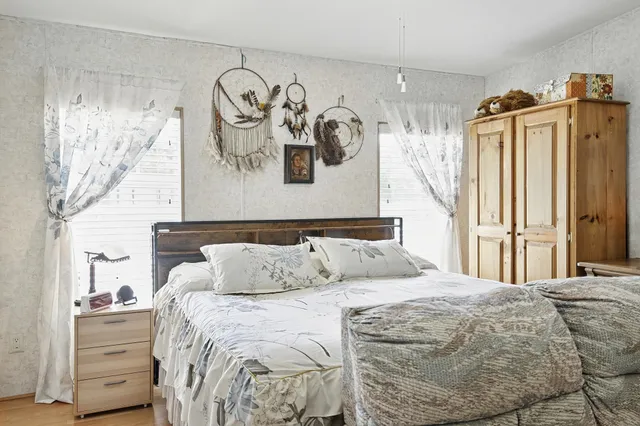 a bedroom with a bed and a table