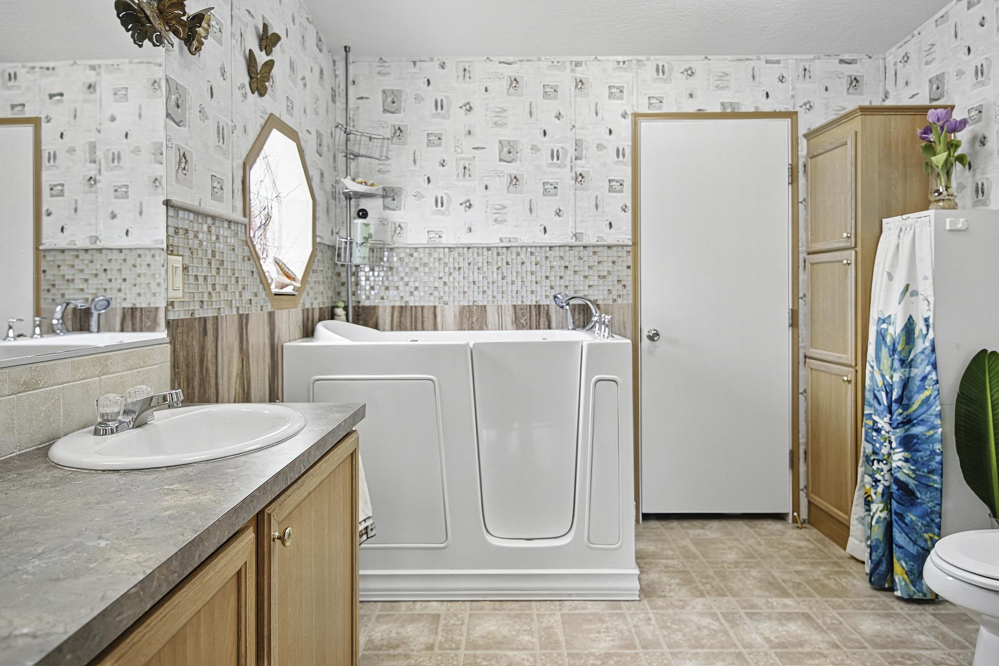 2257 Whippoorwill Drive St. Augustine, FL 32084 - Photo 18 of 50 a bathroom with a sink a mirror a refrigerator and a mirror