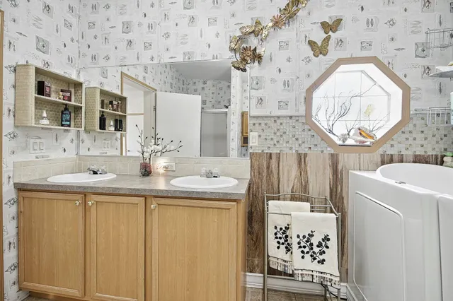 a bathroom with a sink a vanity and a mirror