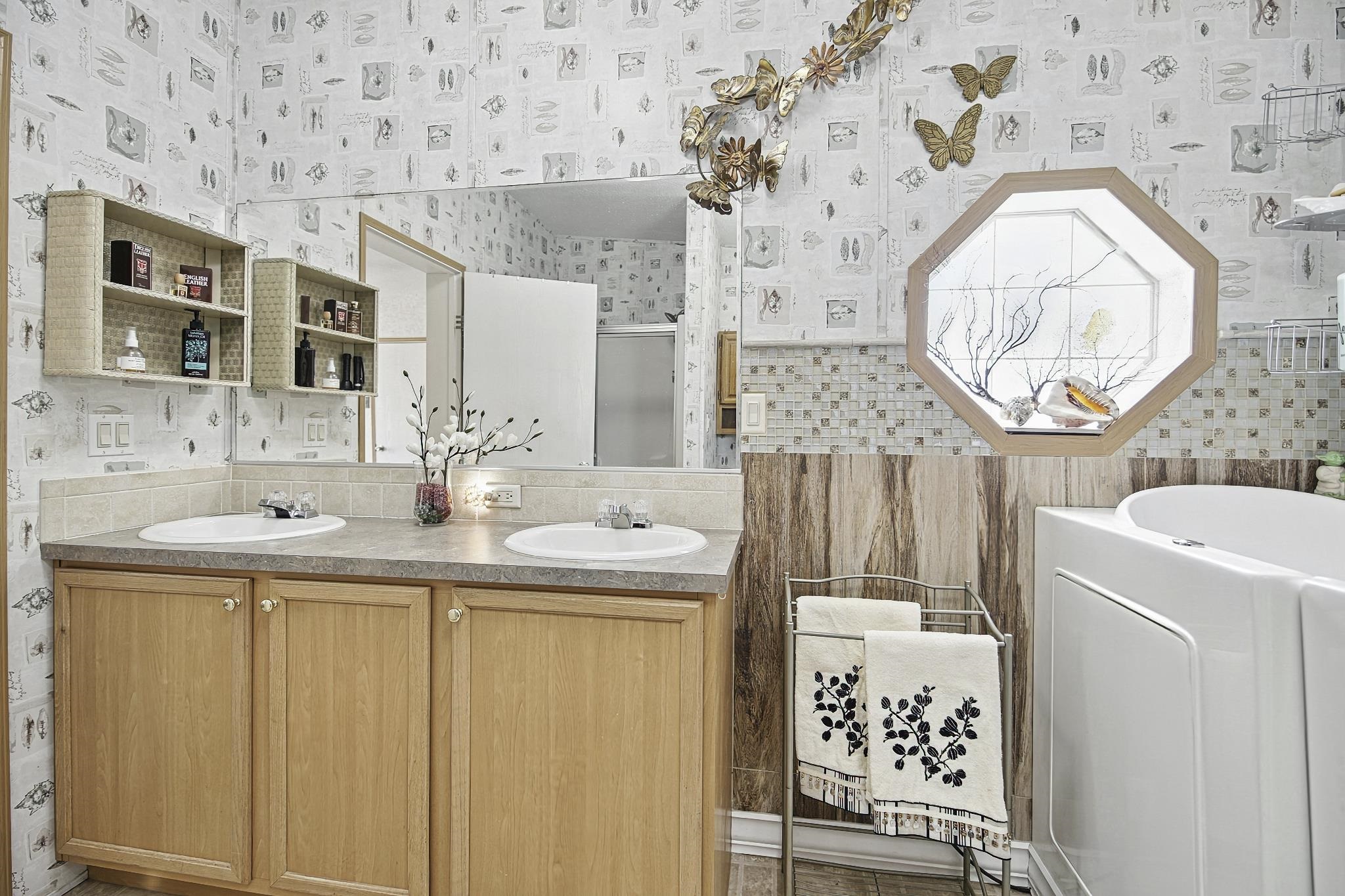 2257 Whippoorwill Drive St. Augustine, FL 32084 - Photo 20 of 50 a bathroom with a sink a vanity and a mirror