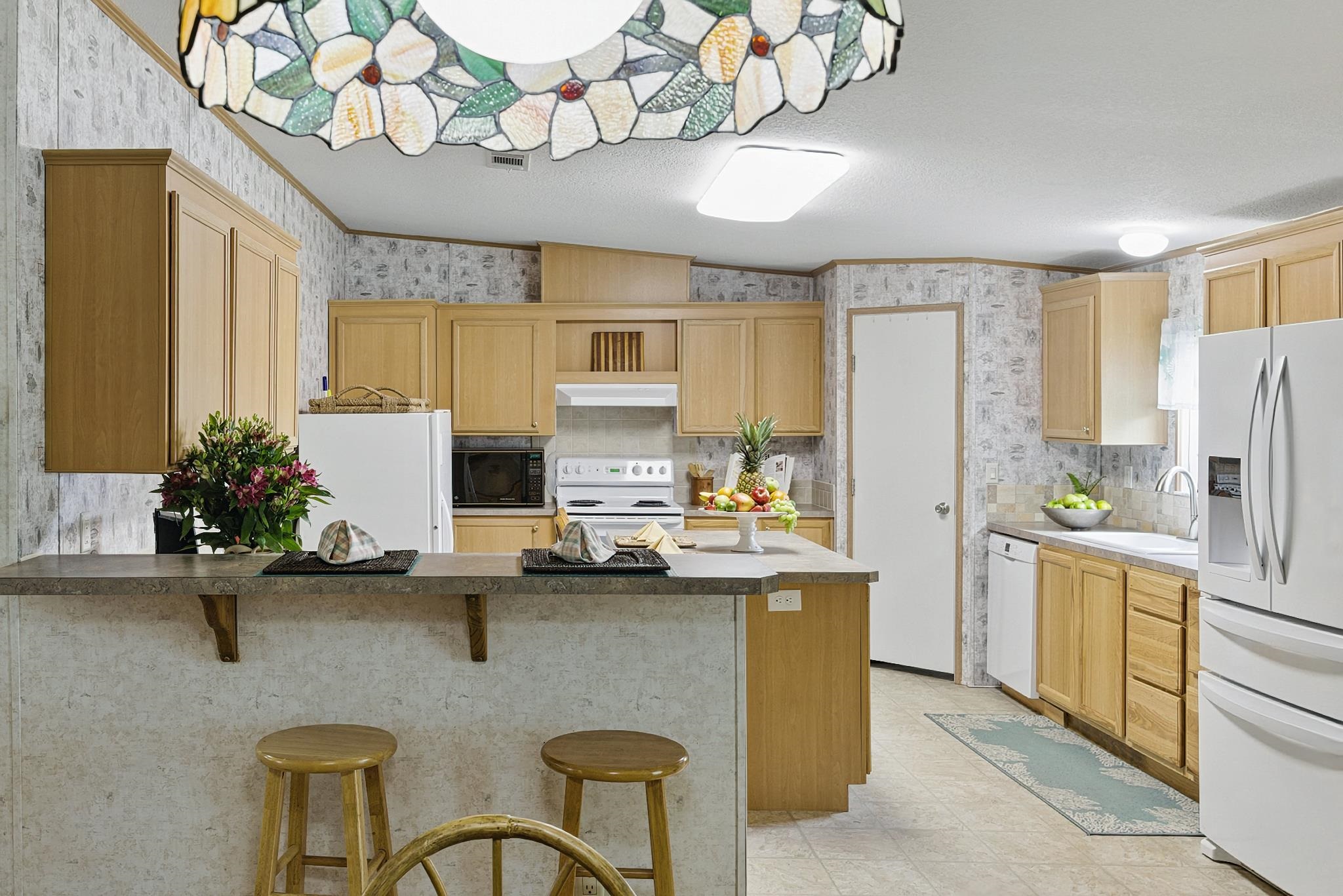 2257 Whippoorwill Drive St. Augustine, FL 32084 - Photo 2 of 50 a kitchen with stainless steel appliances granite countertop a sink refrigerator stove and microwave