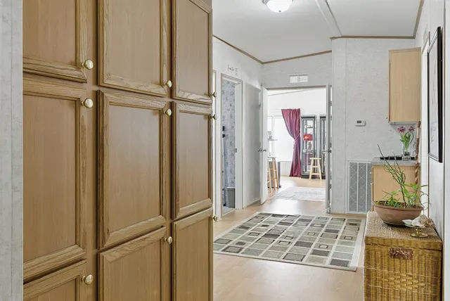 a view of a bedroom with wooden floor and windows