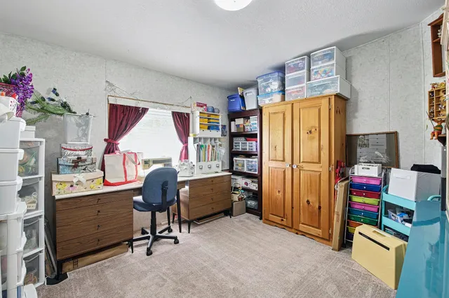 a view of a workspace with furniture and a cabinet