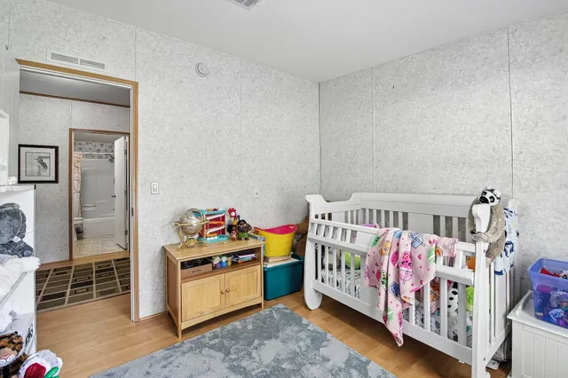 a bedroom with a bed next to a window