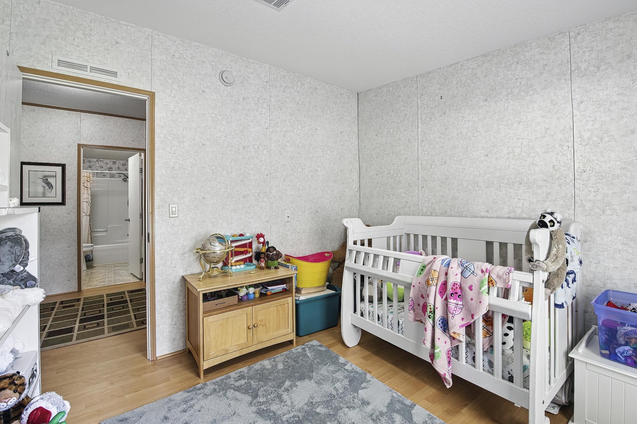 2257 Whippoorwill Drive St. Augustine, FL 32084 - Photo 26 of 50 a bedroom with furniture a baby crib and a dresser