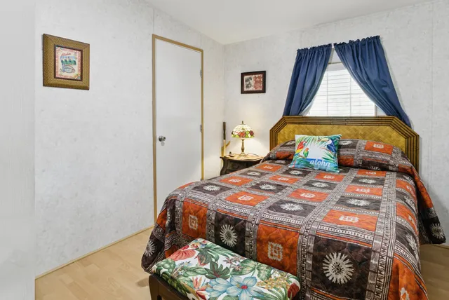 a bed room with a bed and a dresser