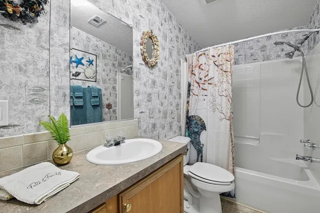 a living room with a rug and a window