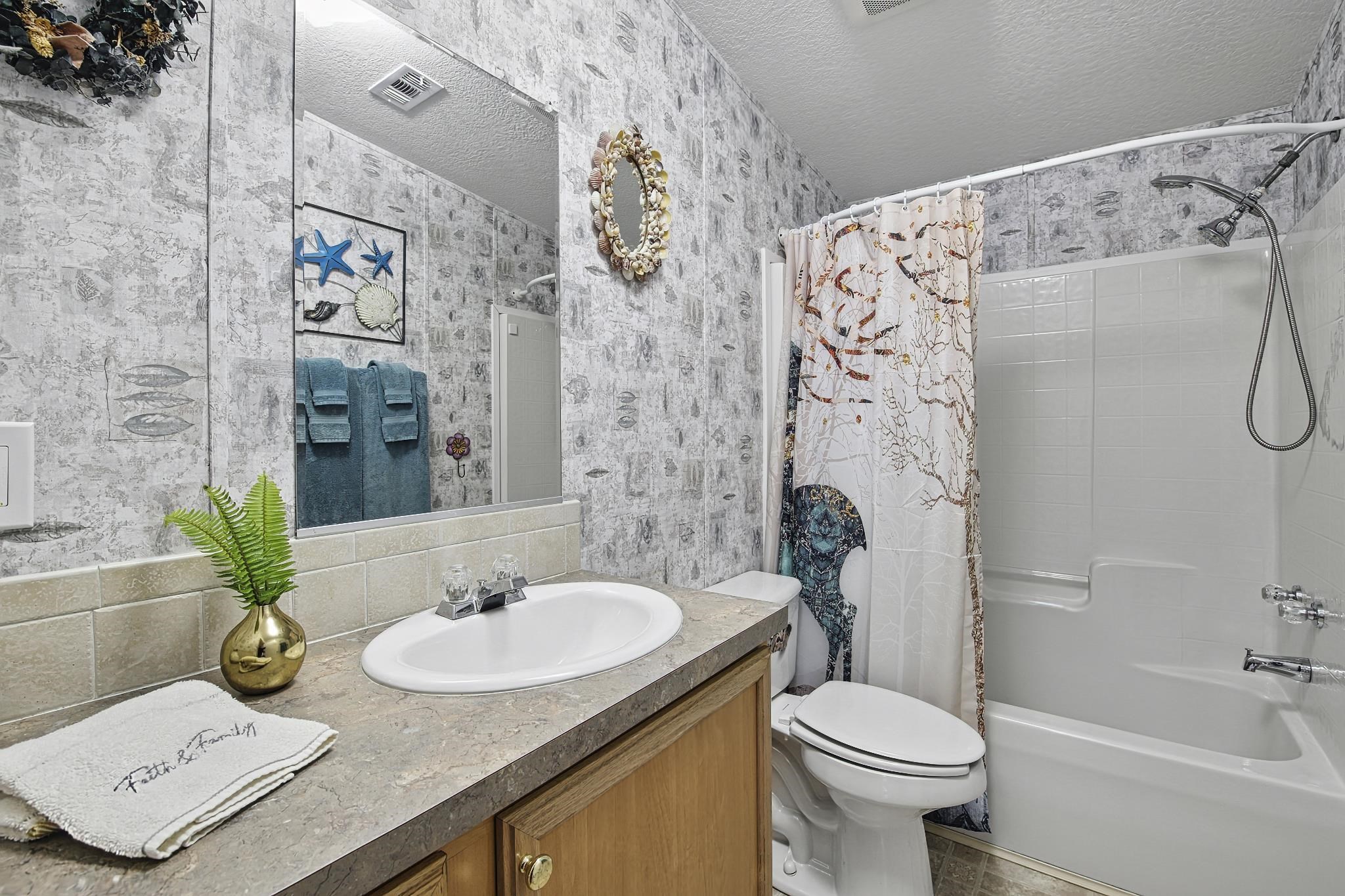 2257 Whippoorwill Drive St. Augustine, FL 32084 - Photo 29 of 50 a bathroom with a sink and a mirror