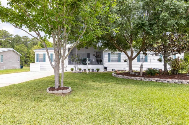 a front view of a house with swimming pool and tree
