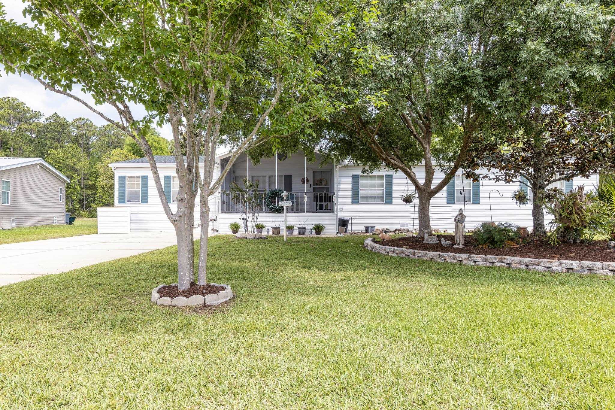 2257 Whippoorwill Drive St. Augustine, FL 32084 - Photo 3 of 50 a front view of a house with swimming pool and tree