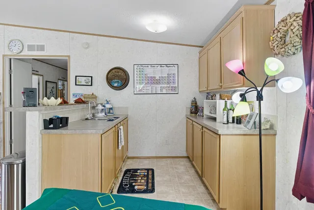 a living room with furniture a rug and a bookshelf