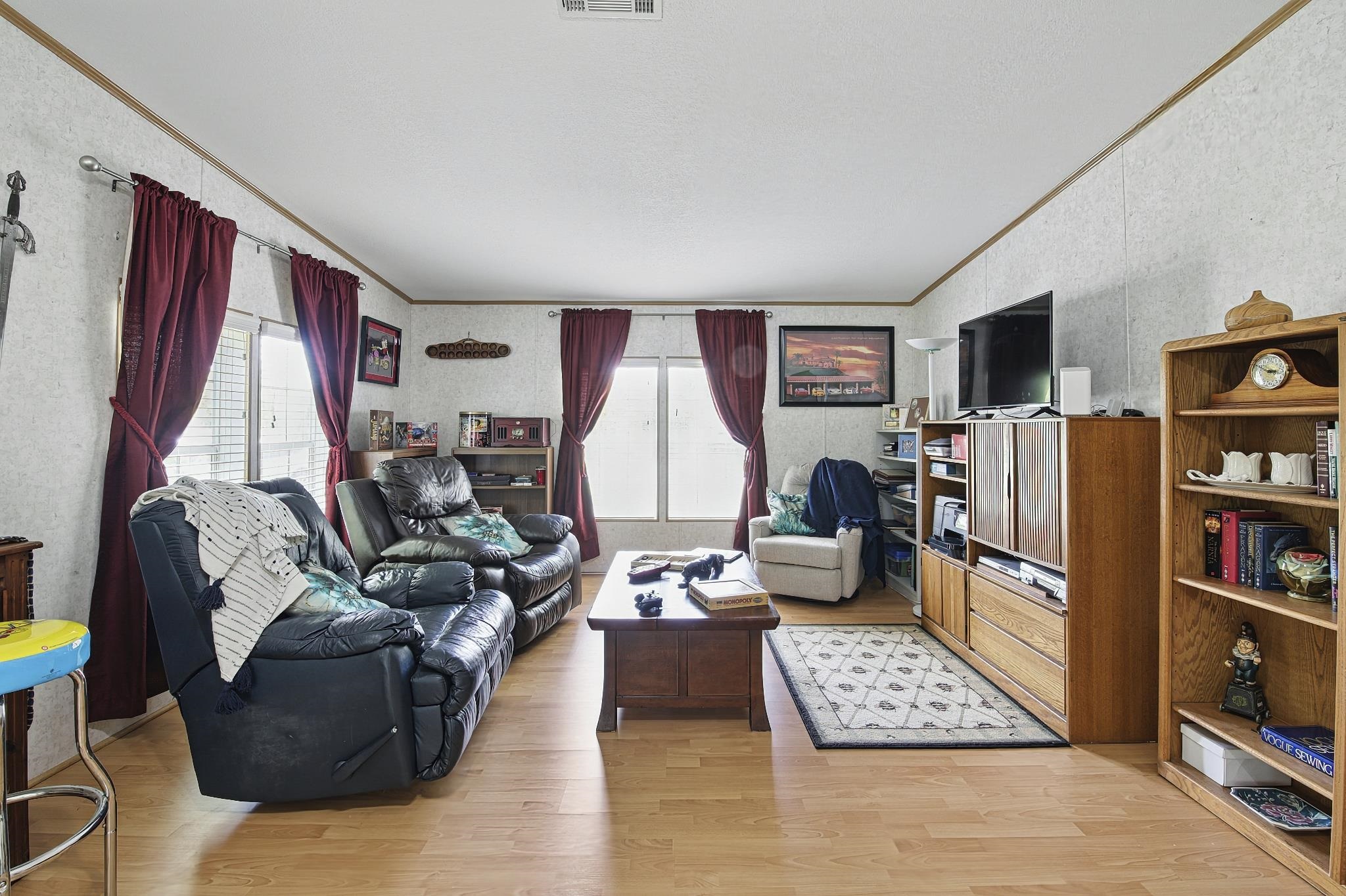 2257 Whippoorwill Drive St. Augustine, FL 32084 - Photo 34 of 50 a living room with furniture a rug and a bookshelf