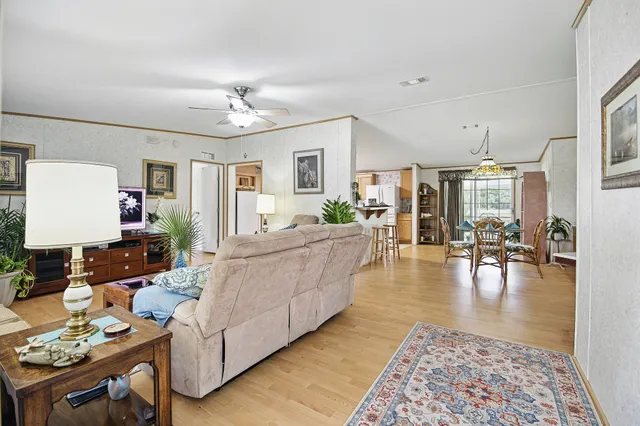 a living room with furniture and wooden floor