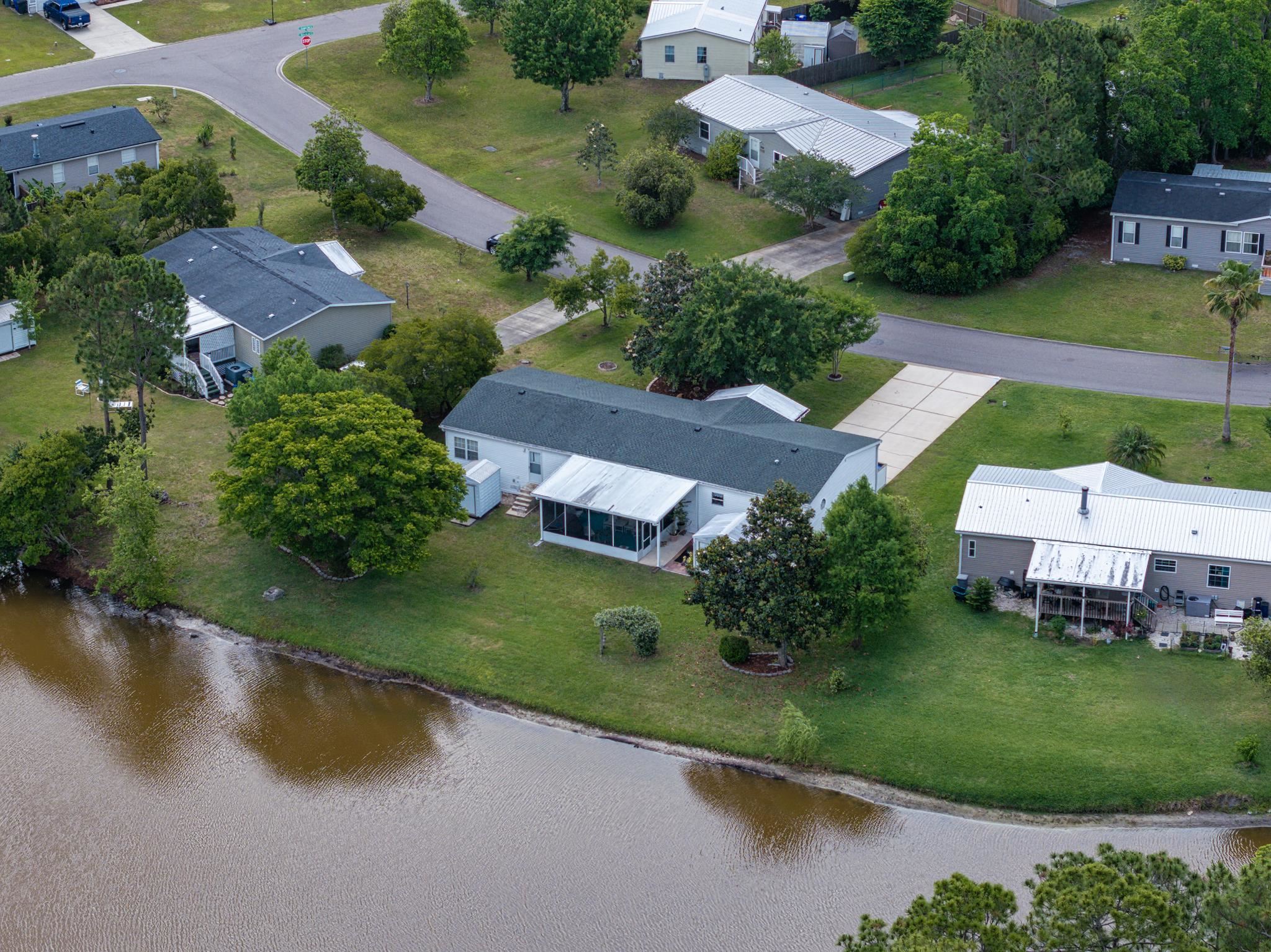 2257 Whippoorwill Drive St. Augustine, FL 32084 - Photo 46 of 50 an aerial view of a house with a garden and lake view