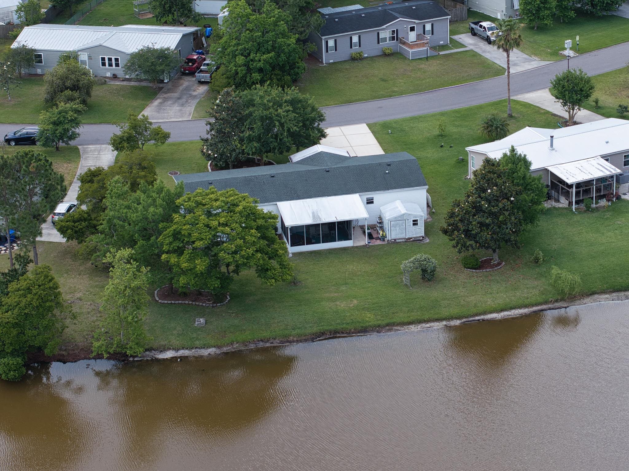 2257 Whippoorwill Drive St. Augustine, FL 32084 - Photo 47 of 50 an aerial view of a house with a garden and lake view