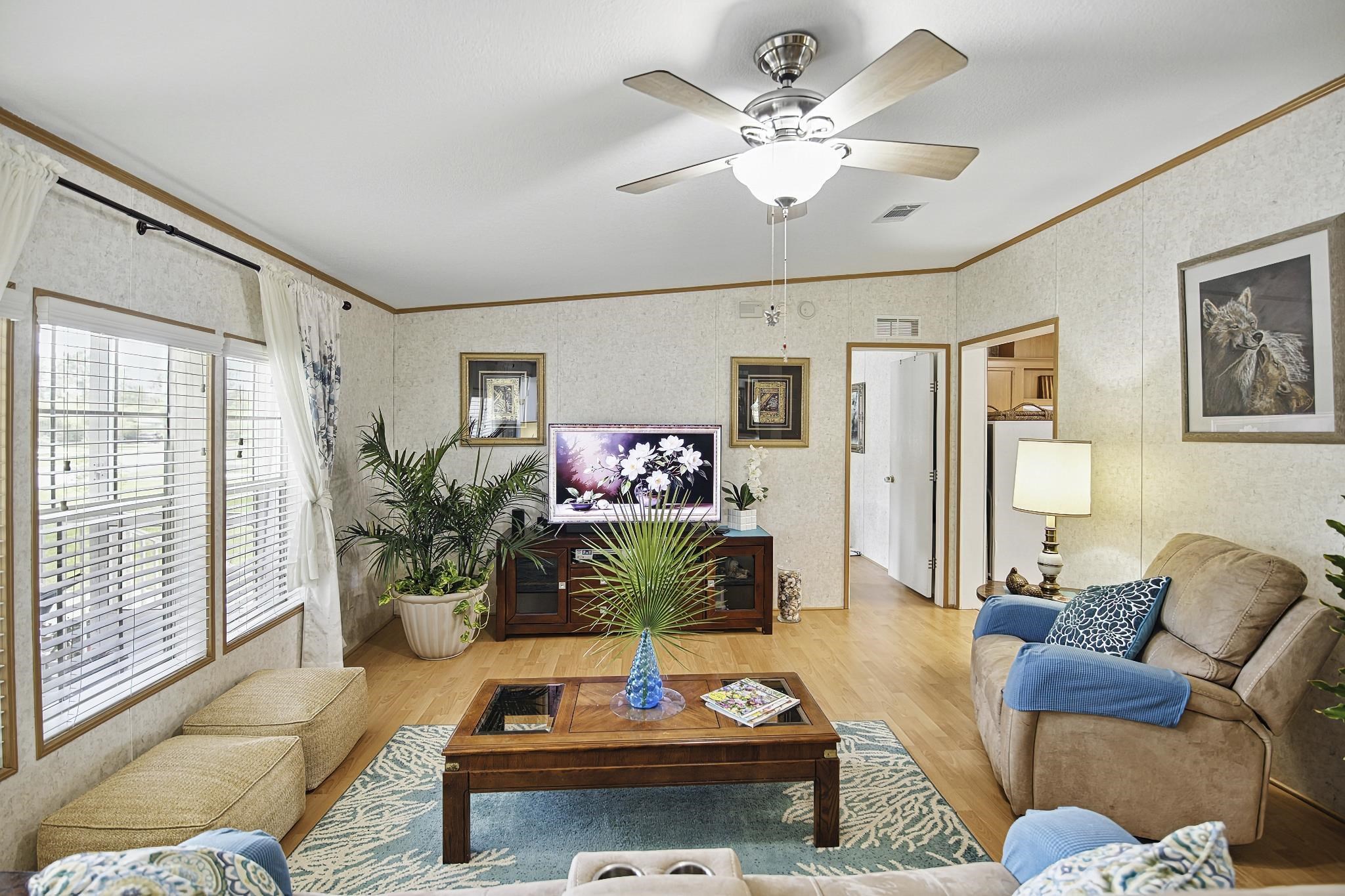 2257 Whippoorwill Drive St. Augustine, FL 32084 - Photo 5 of 50 a living room with furniture potted plant and a flat screen tv