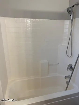 a bathroom with a bath tub with a shower