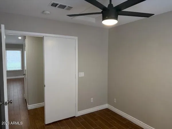 a view of an empty room with wooden floor