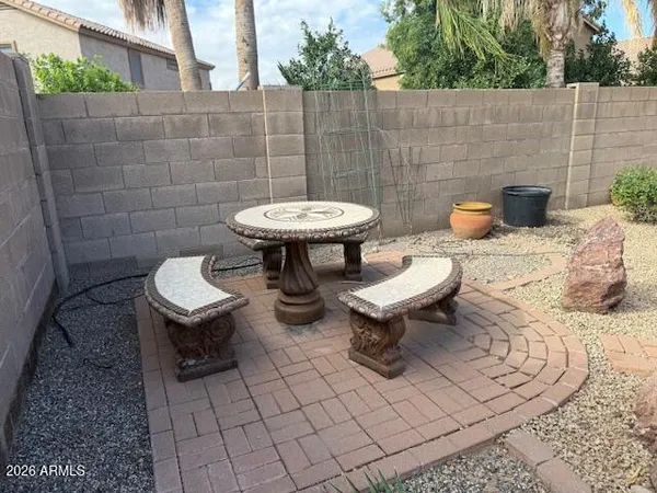 a view of a backyard with furniture and a fountain