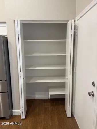 a view of walk in closet with empty racks