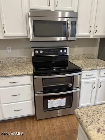 a stove top oven sitting inside of a kitchen