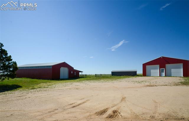 34115 Big Springs Road Yoder, CO 80864 - Photo 26 of 35 View of yard with an outdoor structure and a garage