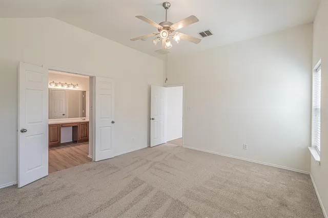 a view of a livingroom with a chandelier fan