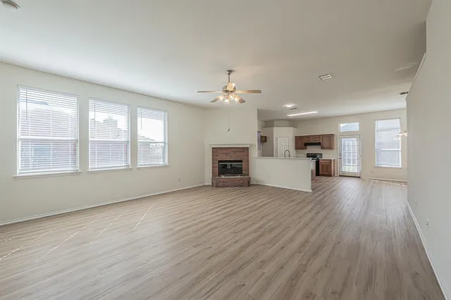 a view of a livingroom with a kitchen wooden floor and a kitchen
