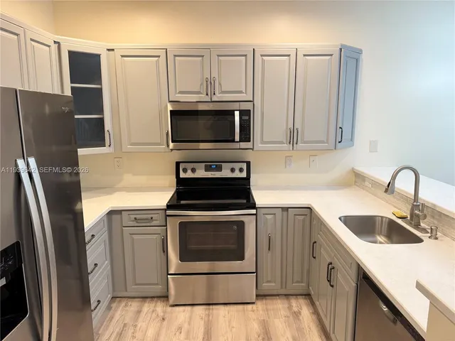 a kitchen with a stove microwave and refrigerator