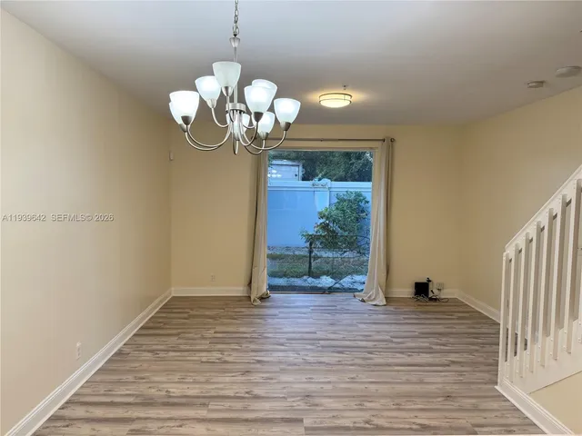 a view of a room with wooden floor