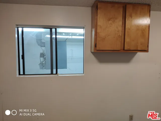 a view of a storage & utility room with a window
