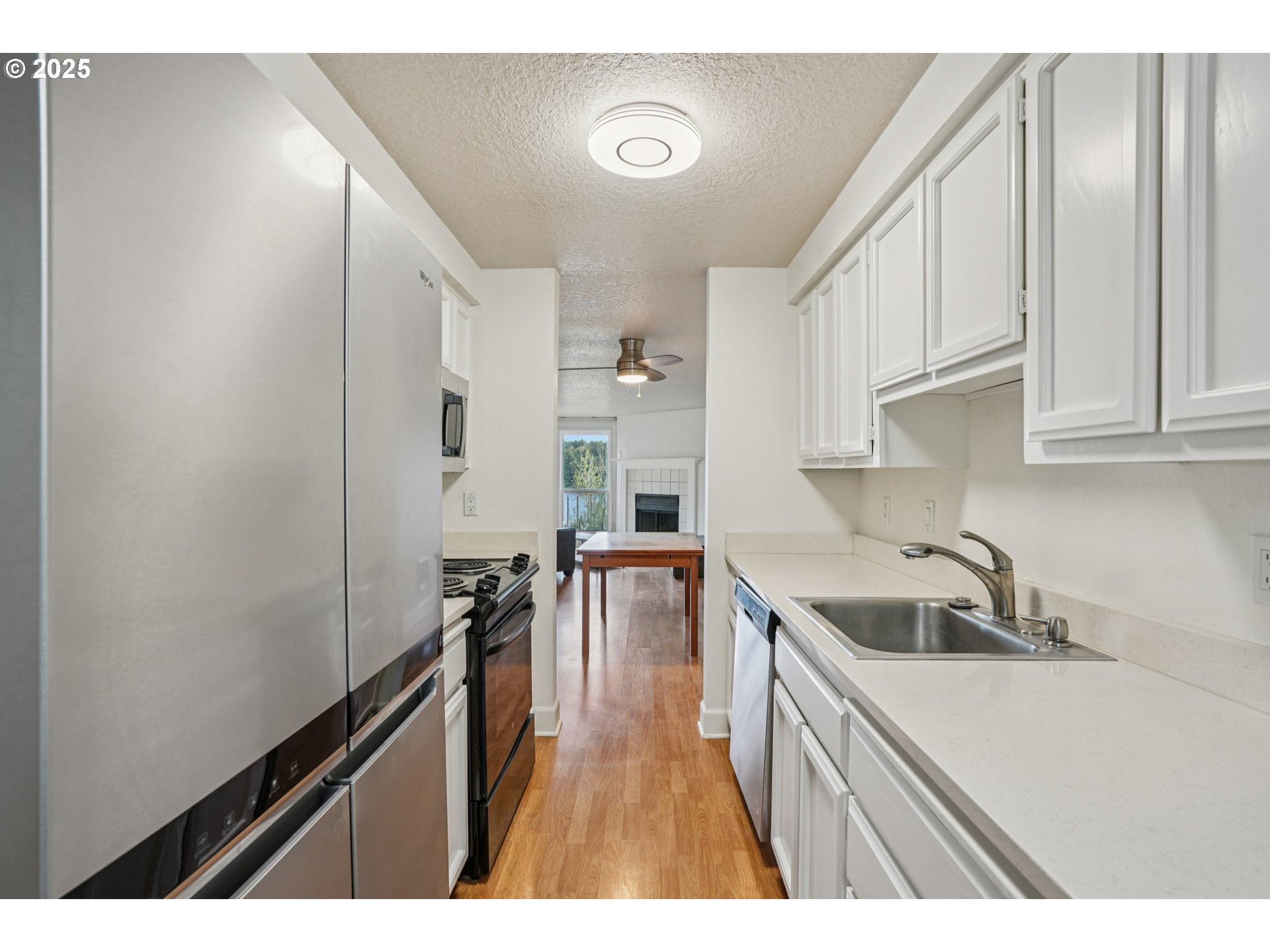 5620 South Riverside Lane, Unit 5 Portland, OR 97239 - Photo 12 of 39 a kitchen that has a sink and cabinets