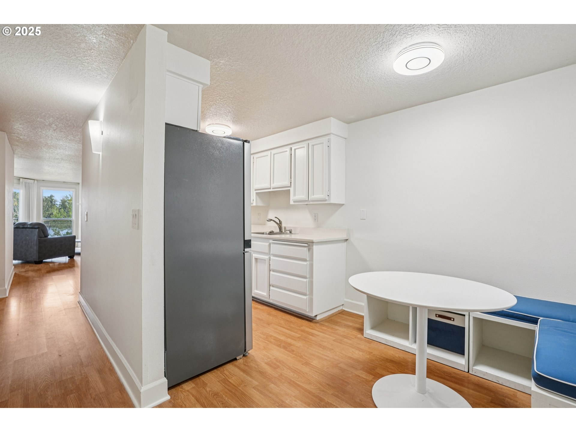 5620 South Riverside Lane, Unit 5 Portland, OR 97239 - Photo 17 of 39 a kitchen with stainless steel appliances a sink cabinets and wooden floor