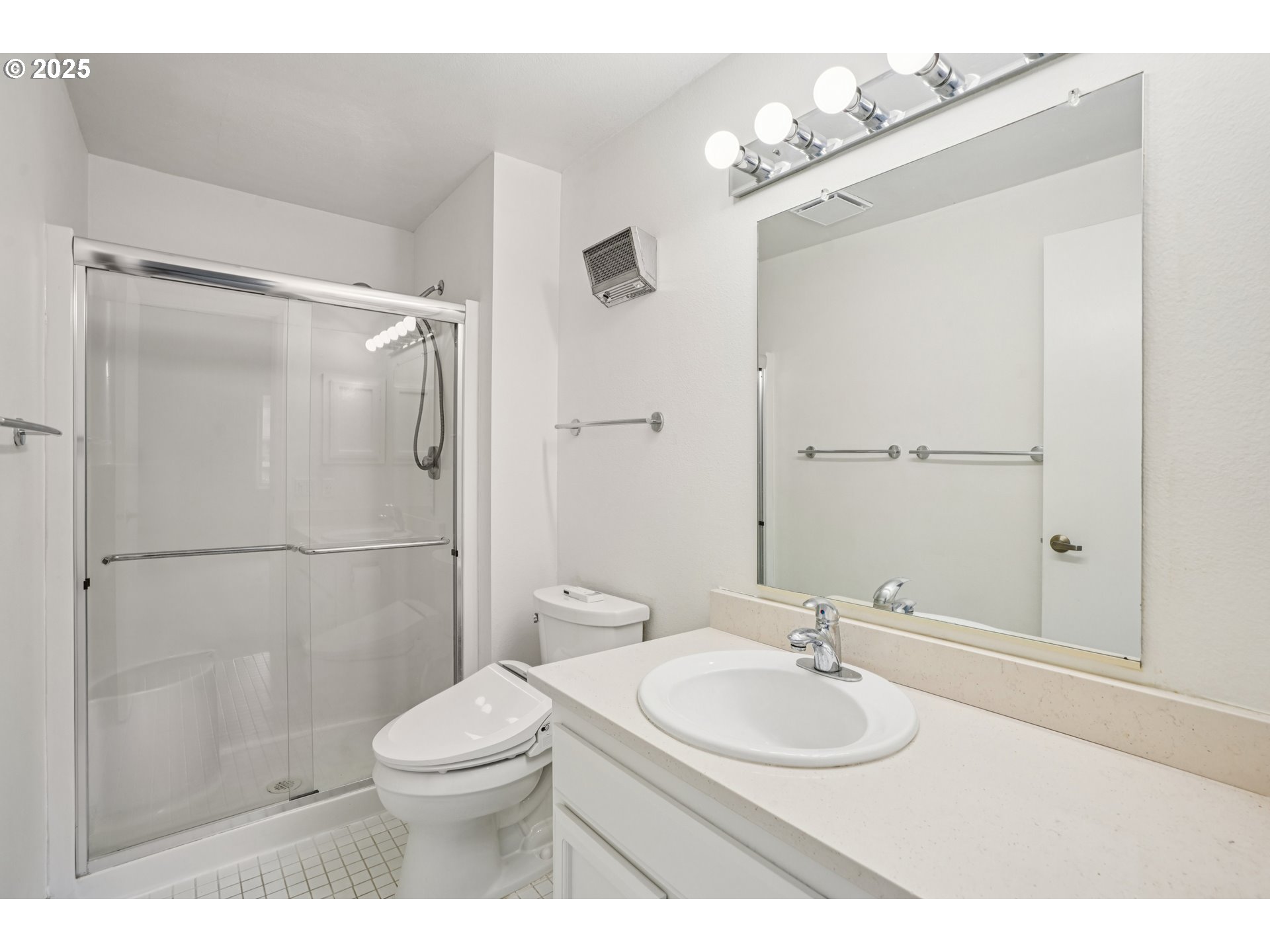 5620 South Riverside Lane, Unit 5 Portland, OR 97239 - Photo 27 of 39 a bathroom with a sink toilet a mirror and shower