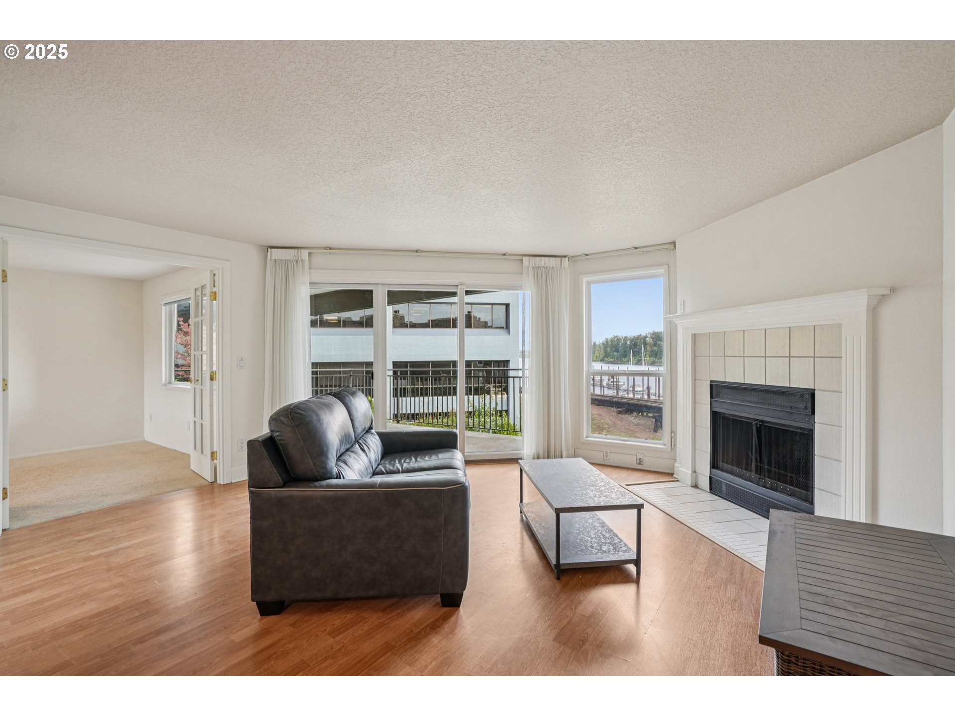 5620 South Riverside Lane, Unit 5 Portland, OR 97239 - Photo 5 of 39 a living room with furniture and a fireplace